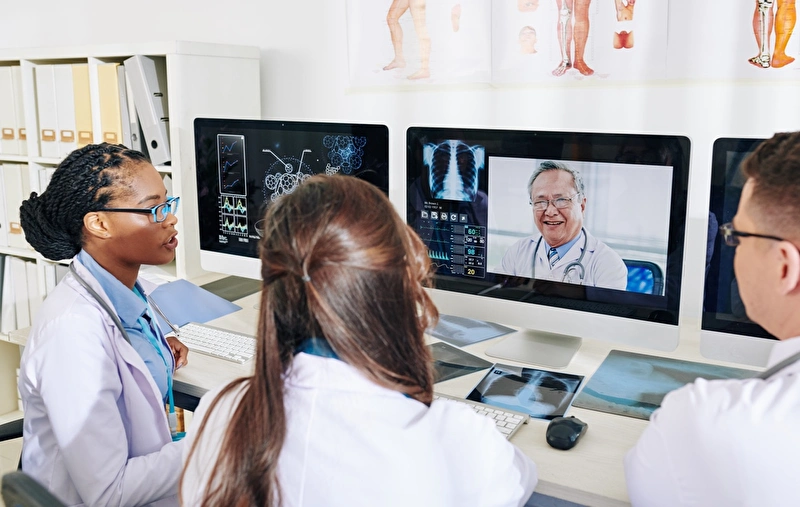 Three scientists on a zoom meeting with another scientist