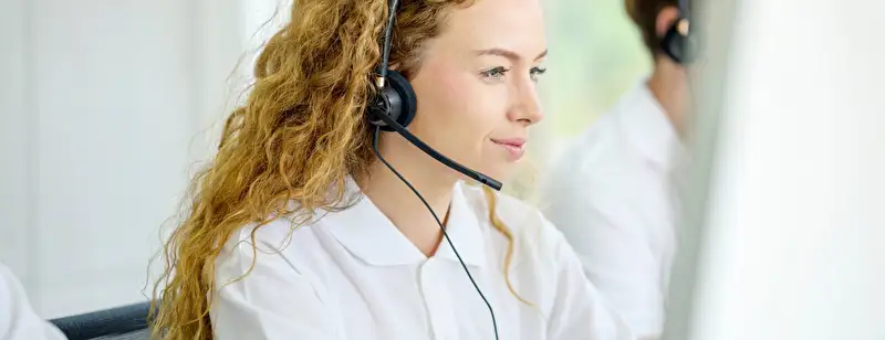 Woman working in support with headphones on