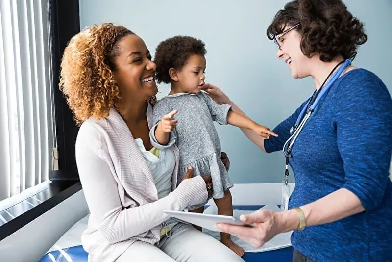 Patients in an examination room. Mother took her child to the doctor.